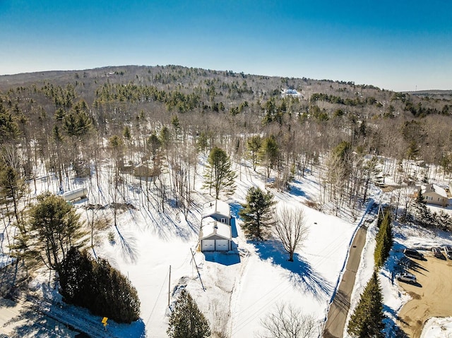 snowy aerial view with a forest view