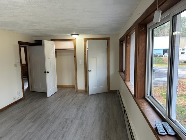 35 Bath Rd, Brunswick, ME 04011 - unfurnished bedroom with baseboards, wood finished floors, and multiple windows