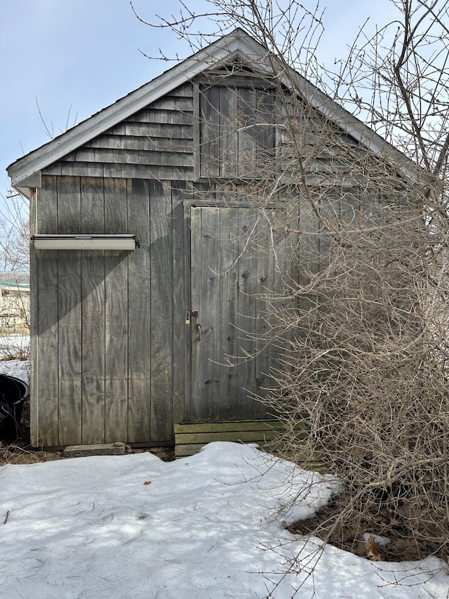 snow covered structure with an outdoor structure