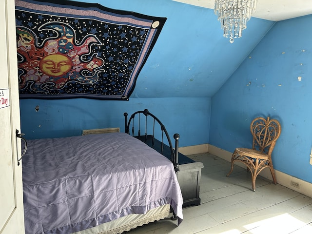 bedroom featuring baseboards, a notable chandelier, and vaulted ceiling