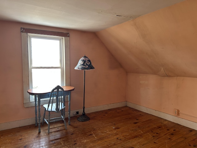 bonus room with hardwood / wood-style floors, vaulted ceiling, and baseboards