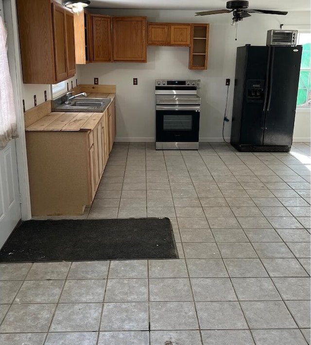 kitchen with electric stove, light tile patterned flooring, black refrigerator with ice dispenser, and a sink