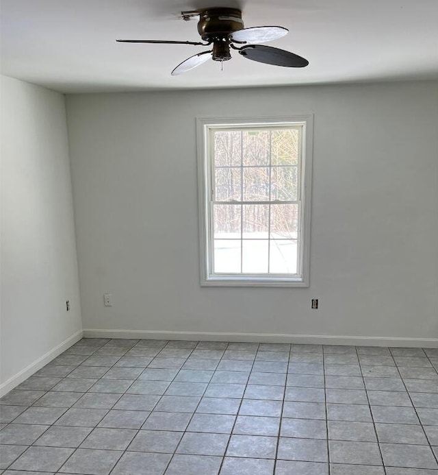 unfurnished room with a ceiling fan, baseboards, and light tile patterned floors