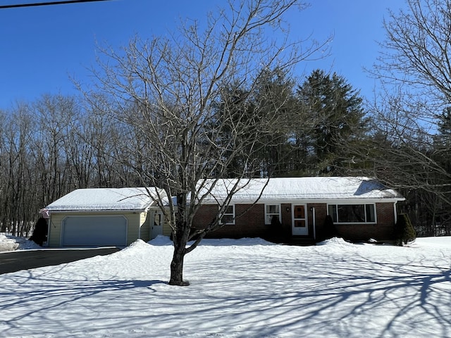 view of front of home featuring brick siding, an attached garage, and aphalt driveway