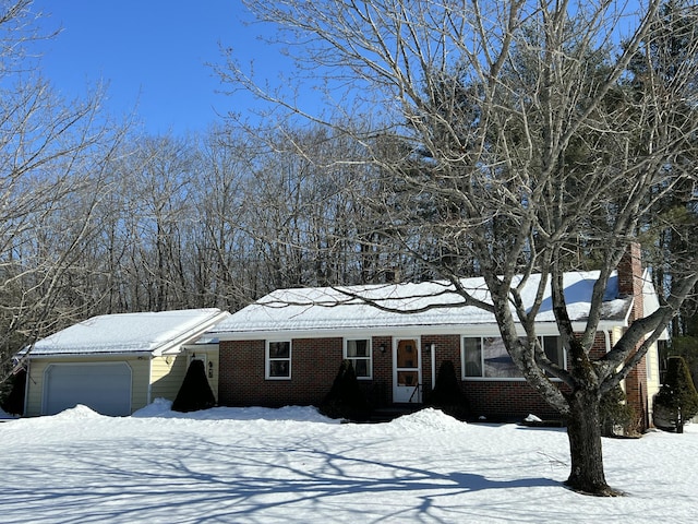 single story home with a garage and brick siding