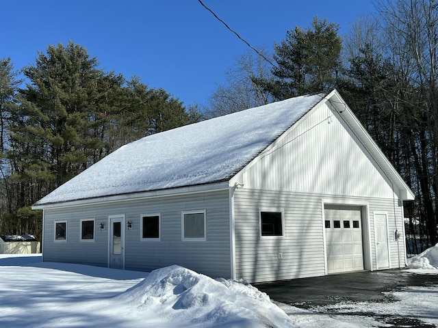 snow covered garage with a garage