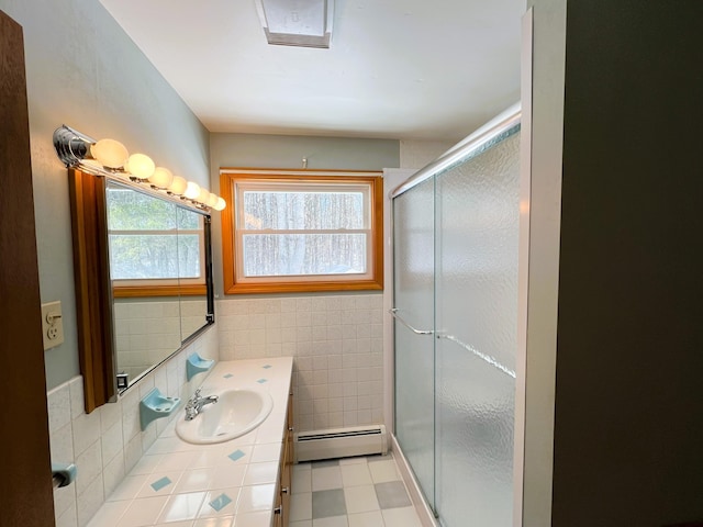 full bathroom featuring visible vents, a baseboard radiator, vanity, a shower stall, and tile walls