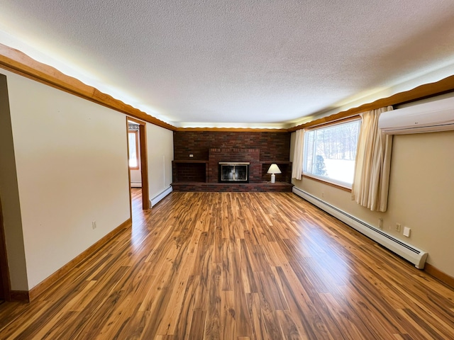 unfurnished living room featuring a baseboard heating unit, a baseboard radiator, a brick fireplace, and wood finished floors