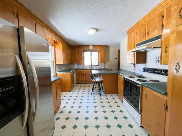 kitchen featuring under cabinet range hood, white range with electric stovetop, stainless steel fridge with ice dispenser, light floors, and brown cabinetry