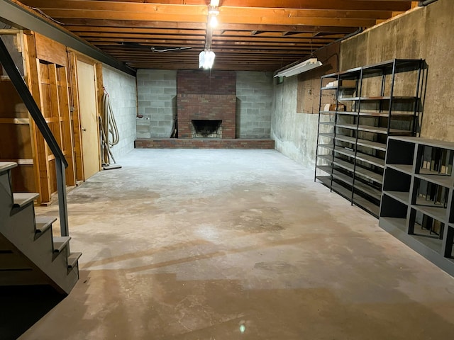 unfinished below grade area featuring stairs and a brick fireplace