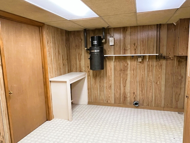 interior space featuring wooden walls and tile patterned floors