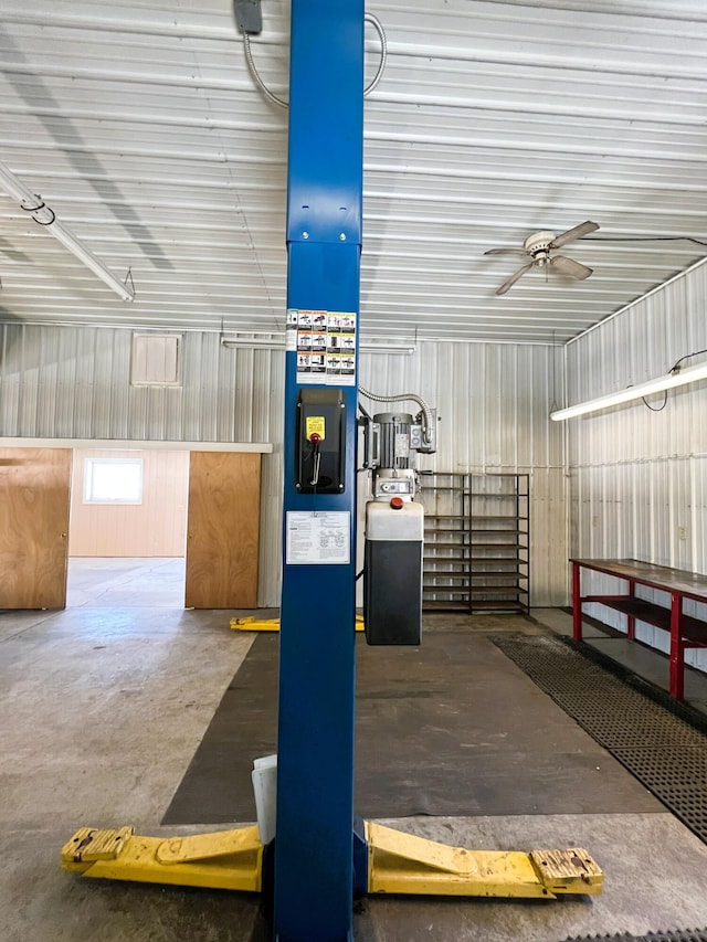 garage featuring metal wall and a ceiling fan