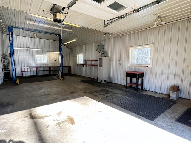 garage featuring metal wall and a garage door opener