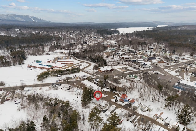 snowy aerial view with a mountain view