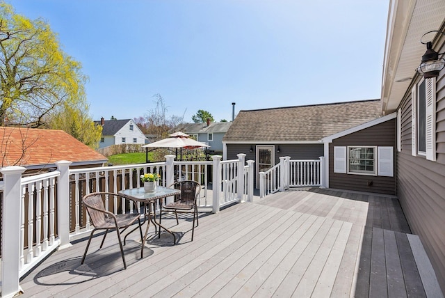 deck featuring a residential view and outdoor dining space