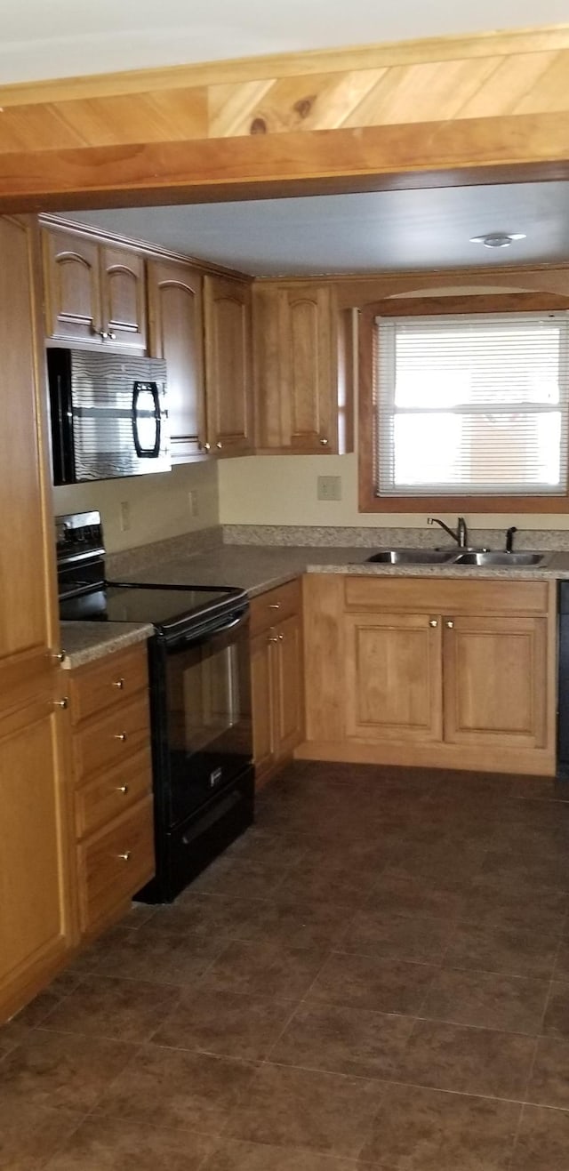 kitchen with black appliances and a sink