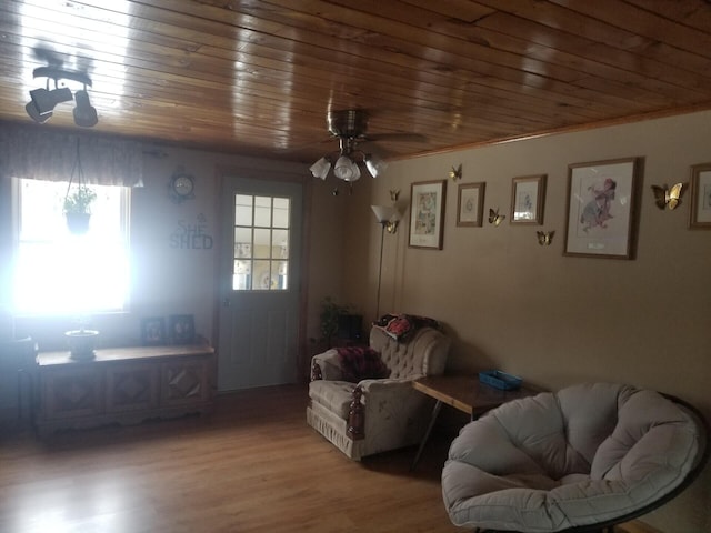 interior space with wood ceiling, ceiling fan, and wood finished floors