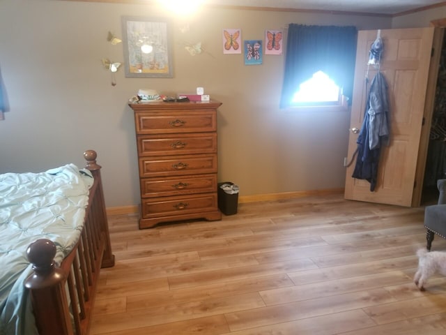 bedroom featuring light wood-type flooring and baseboards