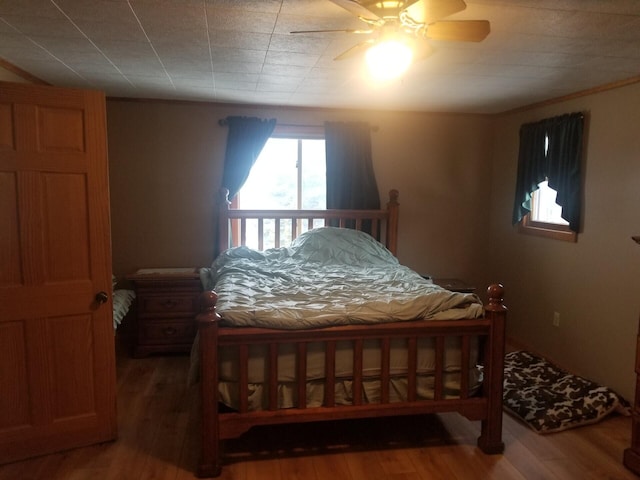 bedroom featuring a ceiling fan and wood finished floors