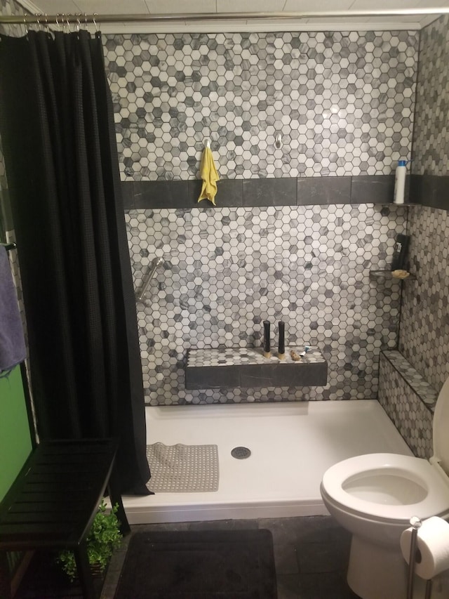 full bathroom with a shower stall and toilet