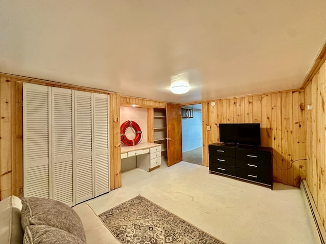 interior space featuring a baseboard heating unit and wood walls