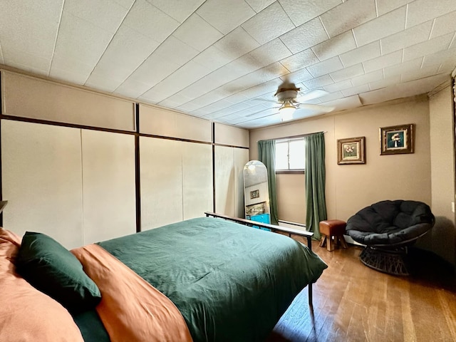 bedroom featuring ceiling fan and wood finished floors