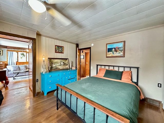 bedroom featuring visible vents and wood finished floors