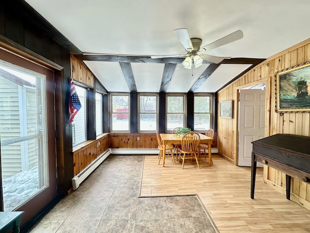 sunroom with vaulted ceiling with beams, a baseboard radiator, and a ceiling fan