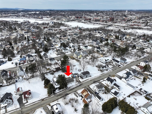 snowy aerial view featuring a residential view