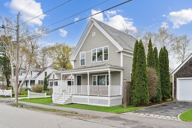 49 Langsford Rd, Kennebunkport, ME 04046 - view of front of home with covered porch, a garage, asphalt driveway, fence, and a shingled roof