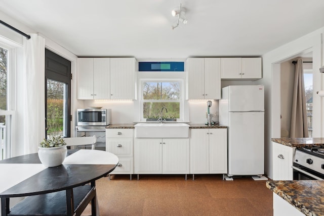 49 Langsford Rd, Kennebunkport, ME 04046 - kitchen featuring appliances with stainless steel finishes, a sink, white cabinets, and dark stone countertops