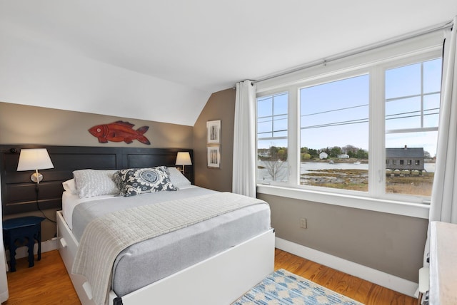 49 Langsford Rd, Kennebunkport, ME 04046 - bedroom featuring lofted ceiling, baseboards, wood finished floors, and a water view