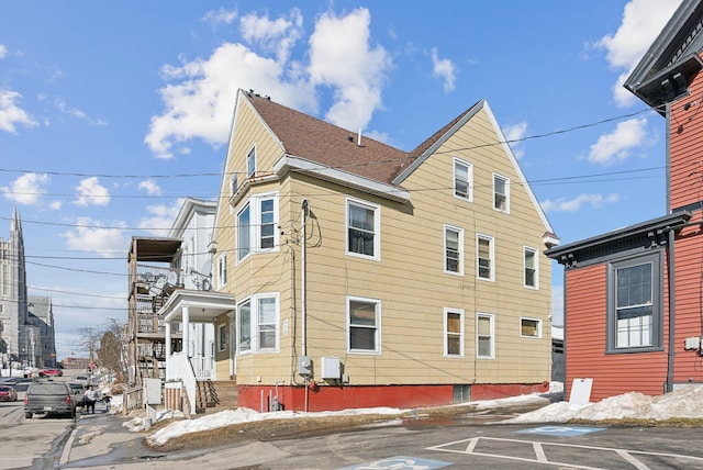 view of home's exterior with a shingled roof