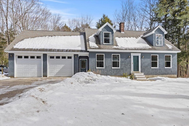 new england style home with a garage and a chimney