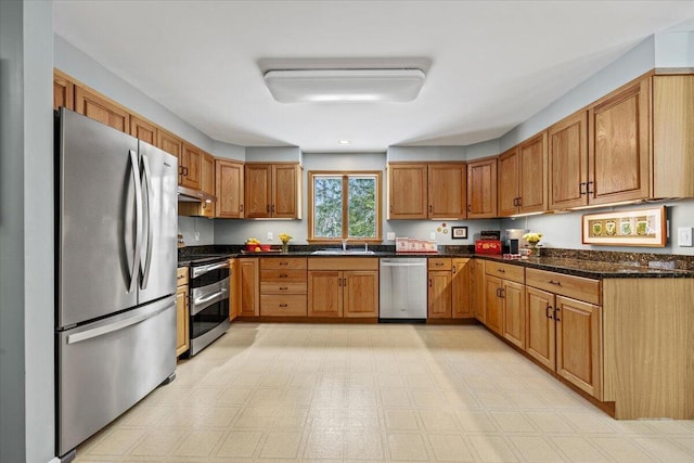 kitchen featuring brown cabinetry, appliances with stainless steel finishes, and under cabinet range hood