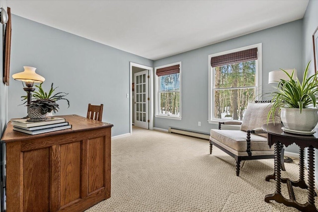 office space with light colored carpet, baseboards, and a baseboard radiator