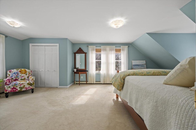 bedroom featuring a closet, baseboards, lofted ceiling, and carpet floors