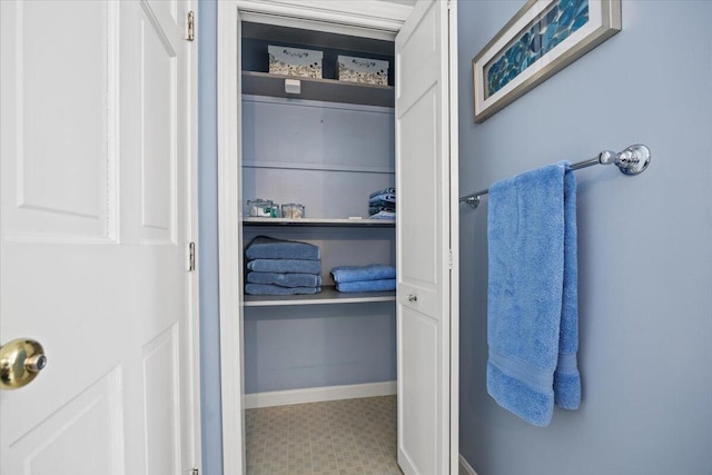 bathroom with tile patterned floors and baseboards