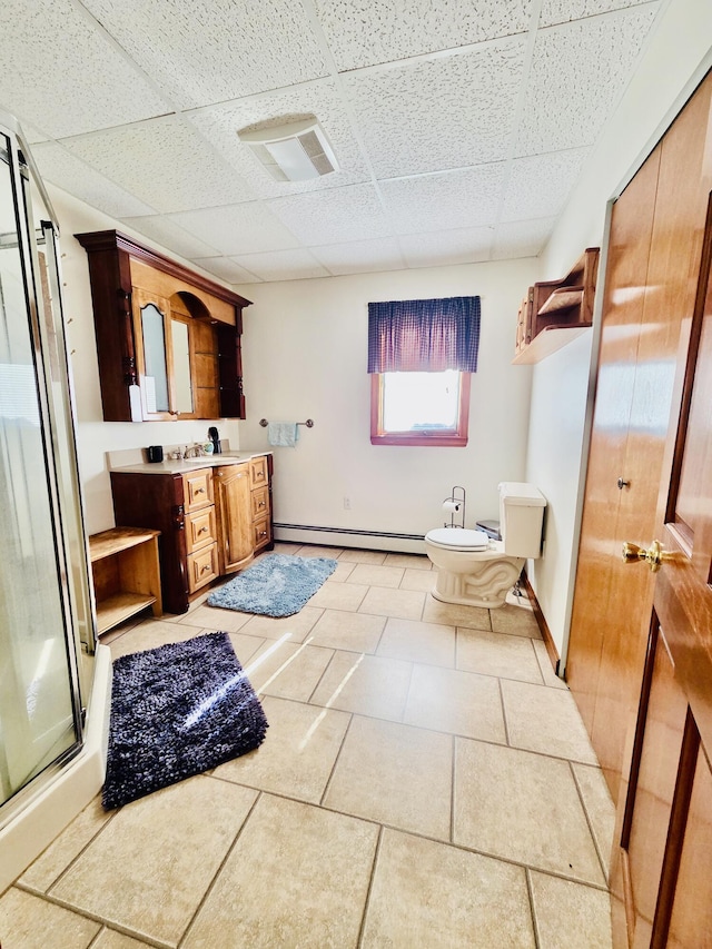 bathroom featuring a stall shower, vanity, a paneled ceiling, a baseboard heating unit, and a bidet