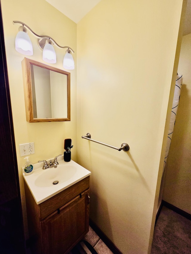 bathroom with baseboards and vanity