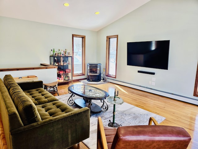 living room with lofted ceiling, recessed lighting, wood finished floors, baseboard heating, and a wood stove