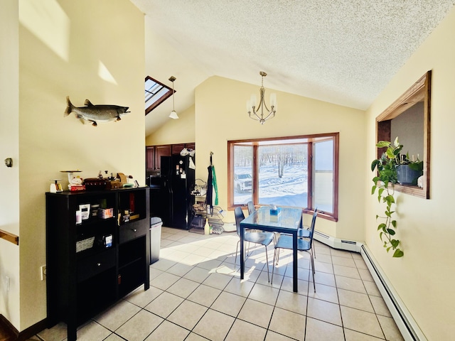 dining room featuring light tile patterned floors, a baseboard heating unit, lofted ceiling with skylight, a textured ceiling, and a chandelier