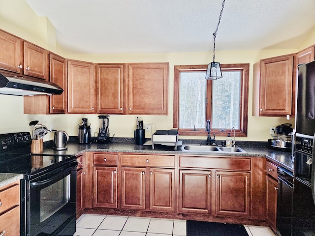 kitchen with light tile patterned floors, dark countertops, a sink, under cabinet range hood, and black appliances