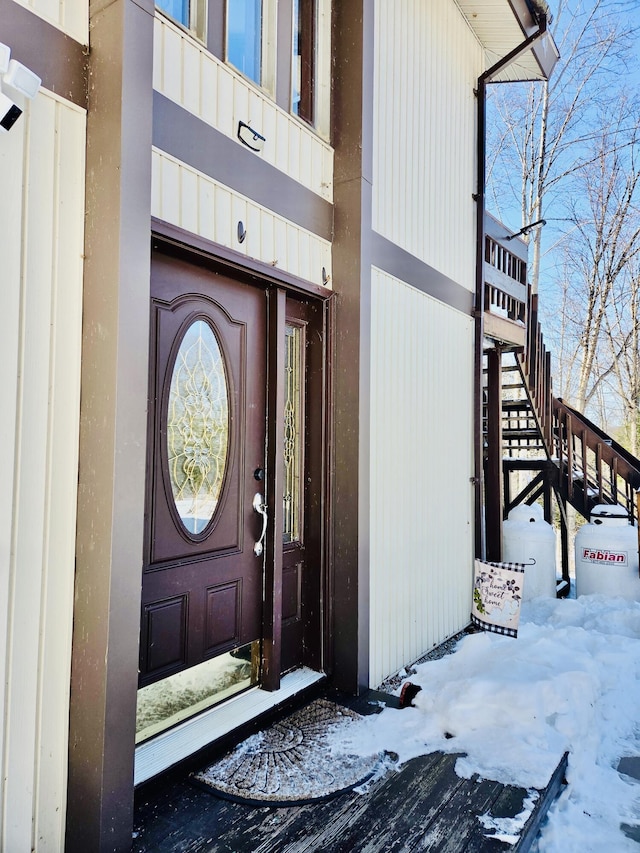 view of snow covered property entrance