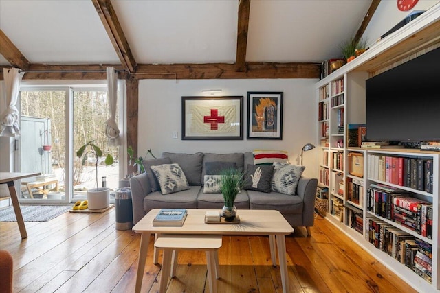 living room featuring beamed ceiling and hardwood / wood-style floors