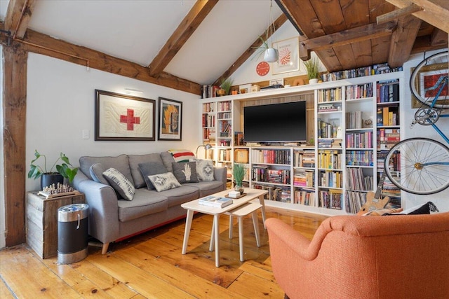 living room with hardwood / wood-style floors and vaulted ceiling with beams