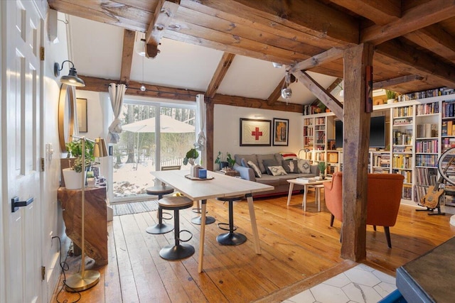 living room featuring lofted ceiling with beams and hardwood / wood-style floors