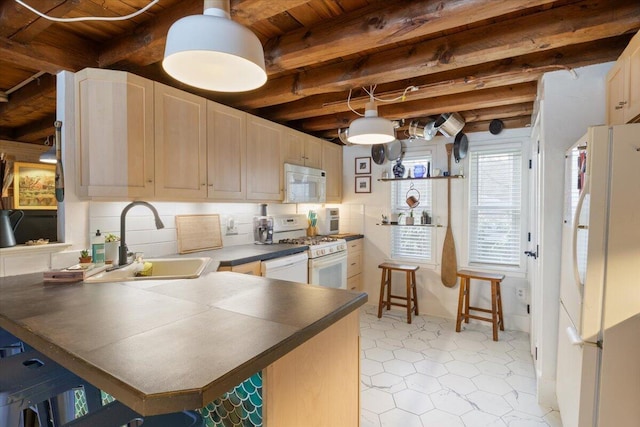 kitchen featuring beamed ceiling, a sink, dark countertops, backsplash, and white appliances