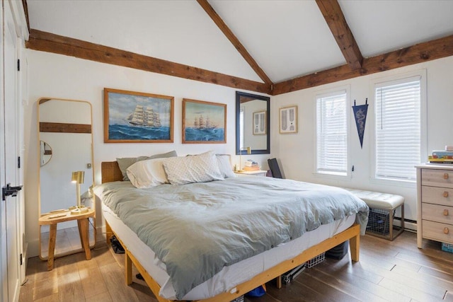 bedroom featuring light wood-style flooring and lofted ceiling with beams