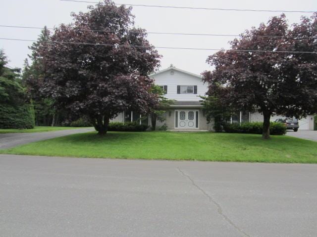131 Clover St, Madawaska, ME 04756 - view of front facade featuring a front yard and driveway